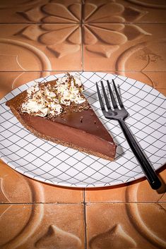 a piece of chocolate pie on a plate with a fork