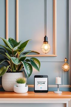 a cell phone sitting on top of a table next to a potted plant