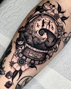 a black and white tattoo with an image of a clock in the middle of it