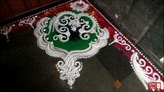 an intricately decorated table top in red, white and green with a tree on it