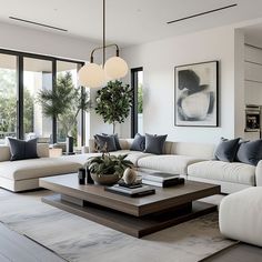 a living room filled with white couches and lots of pillows on top of them