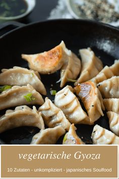 some dumplings are being cooked in a skillet