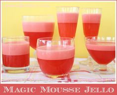 four glasses filled with liquid sitting on top of a table next to each other and the words magic mouse jello