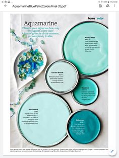 four aquamarine plates sitting on top of a white tablecloth with blue and green accents