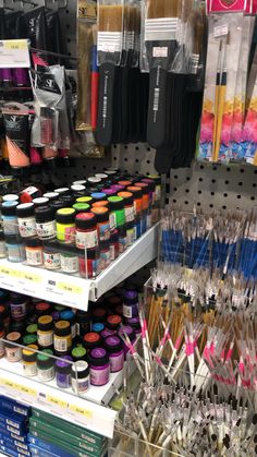 there are many craft supplies on display in the store and one is full of them