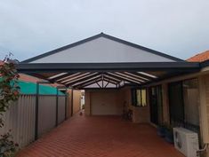 an outdoor covered patio area with brick pavers