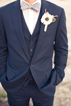 a man in a suit and bow tie