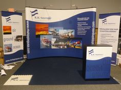 an exhibit booth with blue and white banners