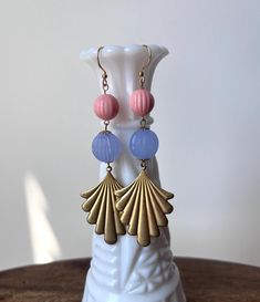 Starting from the top is a vintage coral pink lucite bead connected to another vintage light purple lucite bead on the bottom.  An art deco inspired raw brass component finishes off this simple yet classic design. Hung from raw brass ear wires and measure 3 in. long. ♥ TARA LEA SMITH JEWELRY / HANDMADE in CINCINNATI, OHIO Pink Brass Dangle Earrings, Vintage Pierced Drop Beaded Earrings, Unique Pink Round Bead Earrings, Vintage Beaded Drop Earrings, Vintage Pink Dangle Earrings, Vintage Pink Nickel-free Earrings, Vintage Pink Drop Earrings, Retro Pink Drop Earrings, Retro Handmade Pink Jewelry