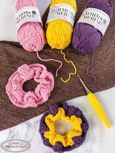 three balls of yarn and two crochet hooks