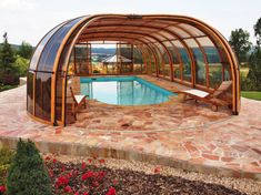 an outdoor swimming pool surrounded by stone and wood