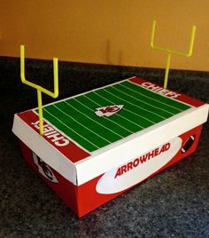 a cardboard box that is shaped like a football field