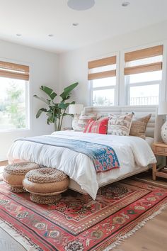 a bedroom with a bed, rugs and two windows in it's corner