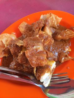 a close up of a plate of food on a table with a fork and knife