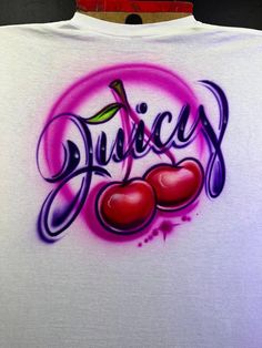 a t - shirt with the word juicy written in purple and red ink on it