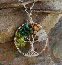 "*Engraving service is not available. Custom Order: Made to order Custom made this unique & gorgeous wire wrapped in this .925 sterling silver tree of life Use following stones. The photos shown using Sapphire,Peridot, Amethyst, Dark Jade All sterling silver wires & chains ~~The pendant measures slightly under 1.30 to 1.35 inch in diameter excluding the bail. It comes with .925 STERLING SILVER chain. ~~ Each pendant is handmade, so please allow slight variations from the shape of the bra Sterling Silver Tree Of Life Nature-inspired Jewelry, Nature-inspired Sterling Silver Wire Wrapped Necklaces, Nature-inspired Wire Wrapped Sterling Silver Necklaces, Unique Sterling Silver Tree Of Life Necklace, Spiritual Sterling Silver Jewelry With Tree Of Life, Nature-inspired Sterling Silver Wire Wrapped Jewelry, Family Tree Of Life, Necklace Birthstone, Peridot Necklace