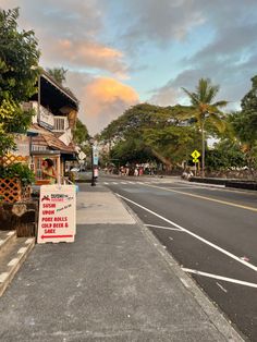 an empty street with a sign on the side