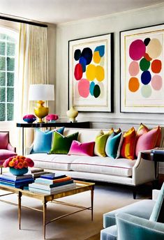 a living room filled with lots of furniture and colorful paintings on the wall above it