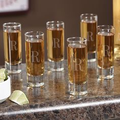 there are many glasses with different types of drinks on the table