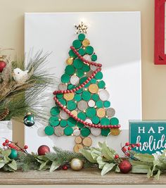 a christmas tree made out of buttons on a mantle