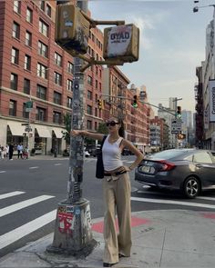 a woman standing next to a traffic light