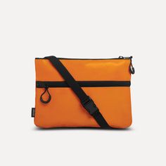 Upcycling at its finest: the UNBEGUN Shoulder Bag. This small shoulder bag with personality is your ideal wingman for any occasion, whether you're hiking through the wilderness or out on the town. The orange shoulder bag is a stylish addition to the UNBEGUN essential bag collection. Where the tarpaulin of Amsterdam market sails used to protect merchants in heavy weather, this recycled material now offers the ultimate protection for your essentials - come rain or shine.   Safely stash your power Orange Square Shoulder Bag With Detachable Strap, Functional Orange Crossbody Bag, Orange Crossbody Bag With Detachable Strap, Orange Eco-friendly Shoulder Bag For Everyday, Functional Orange Shoulder Bag For On-the-go, Recycled Handbag, Orange Crossbody Shoulder Bag For On-the-go, Black Satin Fabric, Small Crosses