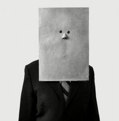 a man in a suit with a paper mask on his face