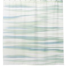 a shower curtain with blue and green waves on it