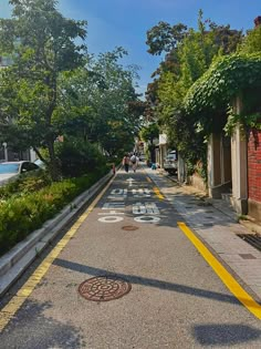 an empty street with people walking down it