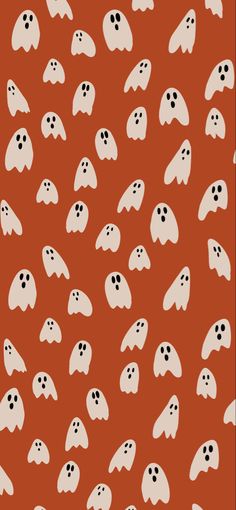 an orange background with white ghost faces on it