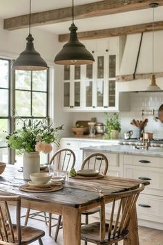 a wooden table with chairs around it in a kitchen