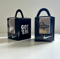 two black and white bags with nike shoes on them, one has a bag that says got'em