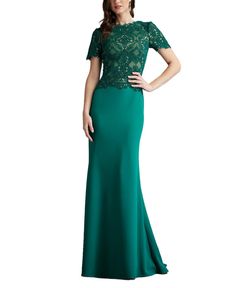 a woman in a long green dress with an open back and lace on the top