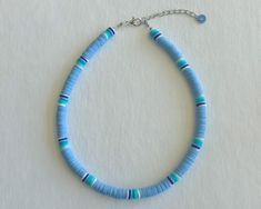 This is The Outer Shore Collection Blue Crush Beaded Necklace. This necklace is inspired by the necklaces that are seen on the Netflix show Outer Banks. We offer this necklace in six different lengths. If you would like the necklace in a different length than what is offered, message me the length you would like after you purchase. This necklace is made of clay polymer heishi beads. Once your order is placed necklaces are handmade and shipped out 1-3 business days. Please message me if you have