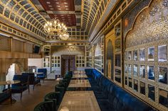 an ornately decorated restaurant with blue velvet booths