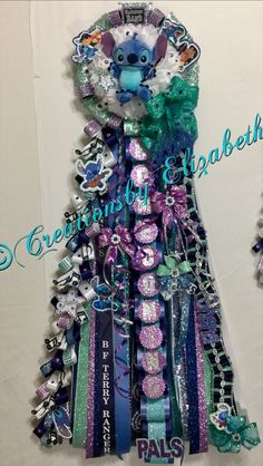 this is an image of a dress made out of bracelets and hair clips in the shape of a tree