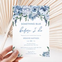 someone is holding up a blue and white wedding card that says something blue before i do