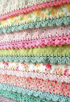 the wall is made up of many different colored crocheted fabrics and ties on it