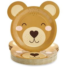 a brown paper plate with a bear face on top of stacks of gold foil plates