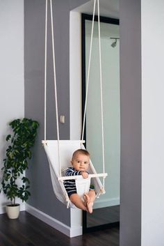 a baby is sitting in a swing