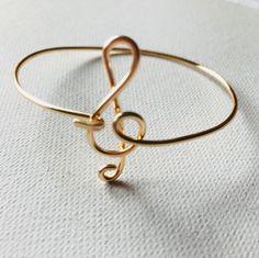 Treble Clef gold bangle Bracelet Made with either gold plated or gold filled 14 gauge wire. A great gift for the musician! Please select material upon check out. A great gift for the musician! Wire Wrapped Gold Bracelet As Gift, Gold Band Cuff Bracelet As Gift, Gold Band Cuff Bracelet Gift, Gold Band Cuff Bracelet For Gifts, Gold Wire Wrapped Bangle For Gift, Gold Wire Wrapped Bracelet Gift, Gift Gold Wire Wrapped Bracelet, Music-themed Band Jewelry As Gift, Music-themed Band Jewelry Gift