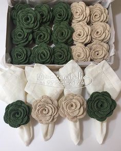 two boxes filled with green and white fabric flowers