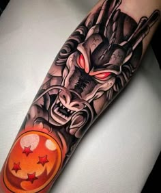 an arm tattoo with a demon on it and a ball in the middle, surrounded by stars