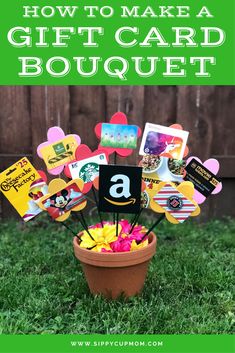 a flower pot filled with lots of cards and magnets on top of green grass