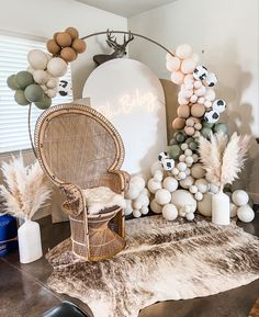 a chair sitting on top of a rug next to balloons and other decorations in a room