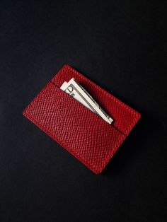 A tiny red Buttero Hatch leather wallet that will easily fit in most pockets. Crafted from red Buttero Hatch leather, this tiny accessory showcases a small coin pouch and slot for a card or two. It can also be used for some cash - an ideal variant for minimalists seeking to carry as little as possible. What is Butter Hatch leather? It is vegetable tanned leather produced by one of the most famous tanneries in the world called Walpier. The leather is prized for its quality and authentic look. It Red Leather Card Holder With Coin Pocket, Red Leather Card Holder With Interior Slots, Red Leather Everyday Card Holder, Red Leather Wallet With Card Slots, Red Leather Card Holder For Daily Use, Red Bifold Wallet For Everyday Use, Red Bifold Card Holder, Red Bifold Card Holder With Interior Slots, Red Formal Card Holder With Rfid Blocking