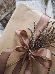 a present wrapped in brown paper and tied with a ribbon