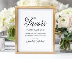 a table topped with vases filled with flowers and a framed sign that says favors