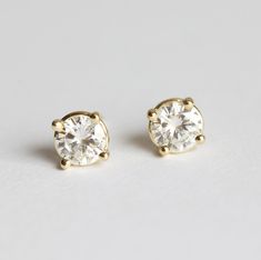 A pair of MOISSANITE studs in 14k YELLOW gold is already made and ready to be shipped. A pair of simple and minimalist shiny half carat round white diamond or Forever One moissanite prong set earring studs in 14k solid rose, white or yellow gold. Perfect as an elegant and sparkling wedding anniversary gift for her. The design can be made with gemstones of your choosing. If you would prefer custom earrings, please contact us before purchase. ★Details Gemstones: round genuine white diamonds (or mo Yellow Gold Single Cut Diamond Earrings For Anniversary, Anniversary Yellow Gold Earrings With Single Cut Diamonds, Moissanite Yellow Gold Round Diamond Earrings, Yellow Gold Moissanite Diamond Earrings, White 14k Gold Earrings With Single Cut Diamonds, Timeless Gold Diamond Earrings For Wedding, Classic Yellow Gold Diamond Earrings, Vvs Clarity Round Cut Diamond Earrings For Wedding, Classic Yellow Gold Clip-on Diamond Earrings