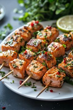 several skewers of food on a plate with garnishes and lemon wedges